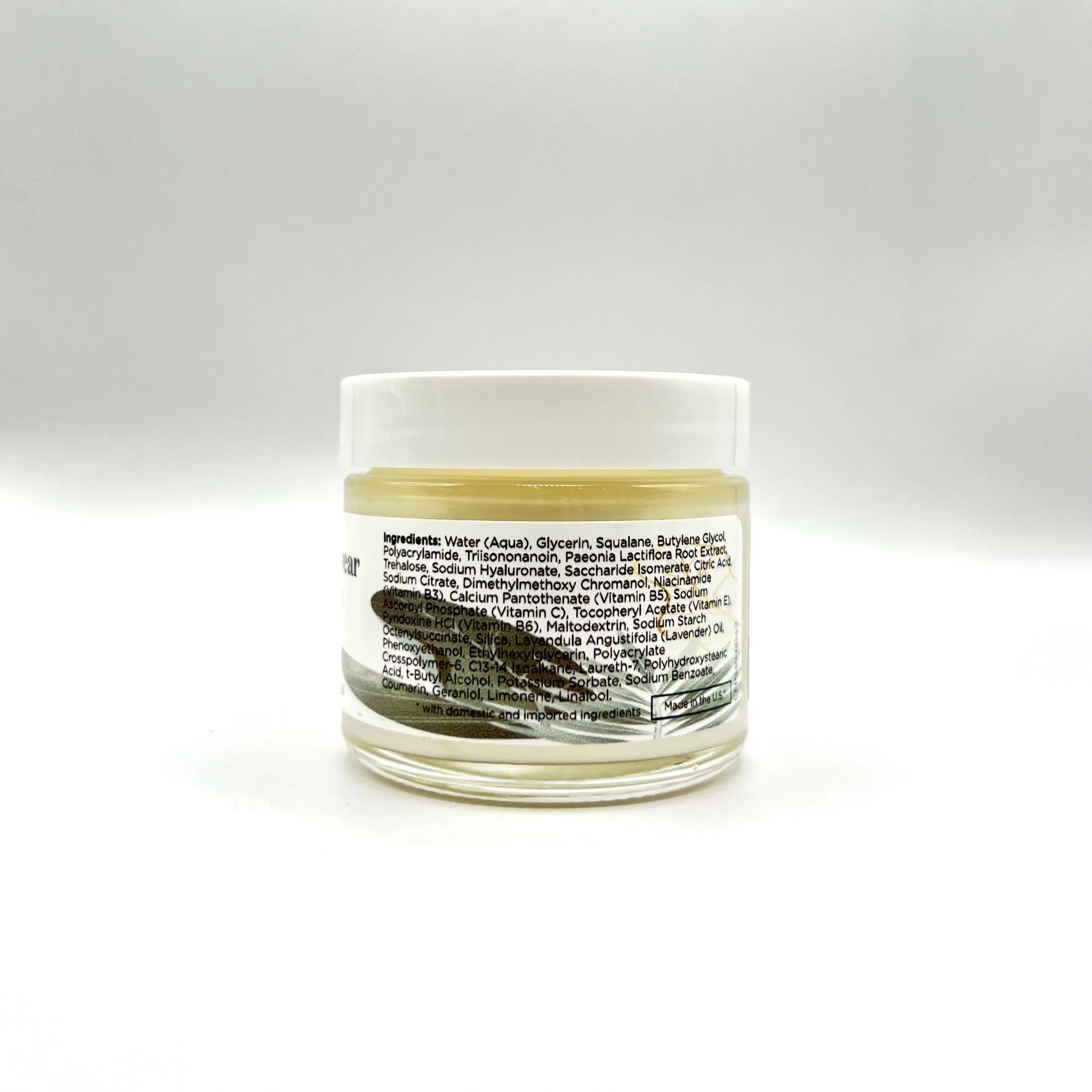 A clear jar labeled "Detox Nightwear Cream" with a white label displaying the ingredients on its side, set against a plain background.