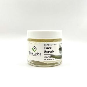 Jar of Exfoliating Face Scrub with fruit extracts and jojoba beads on a white background.